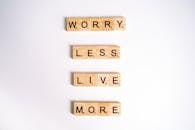 Close-Up Shot of Scrabble Tiles on a White Surface