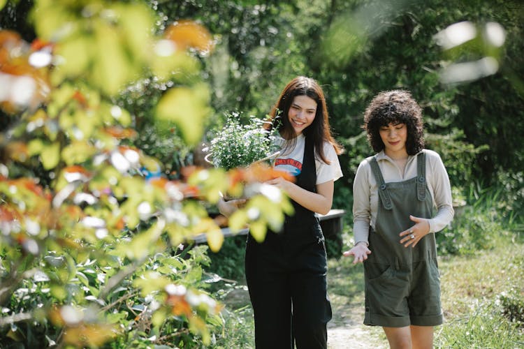 Happy Young Friends Walking In Summer Garden