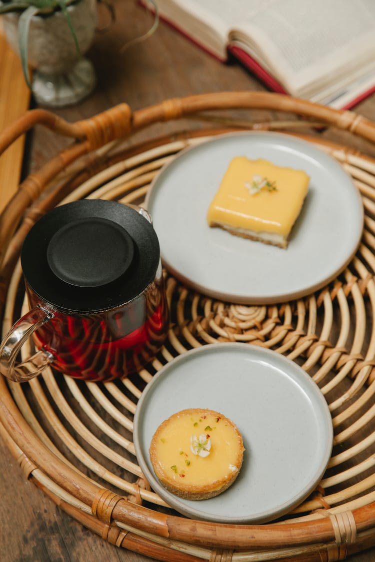 Teapot And Desserts On Wicker Tray