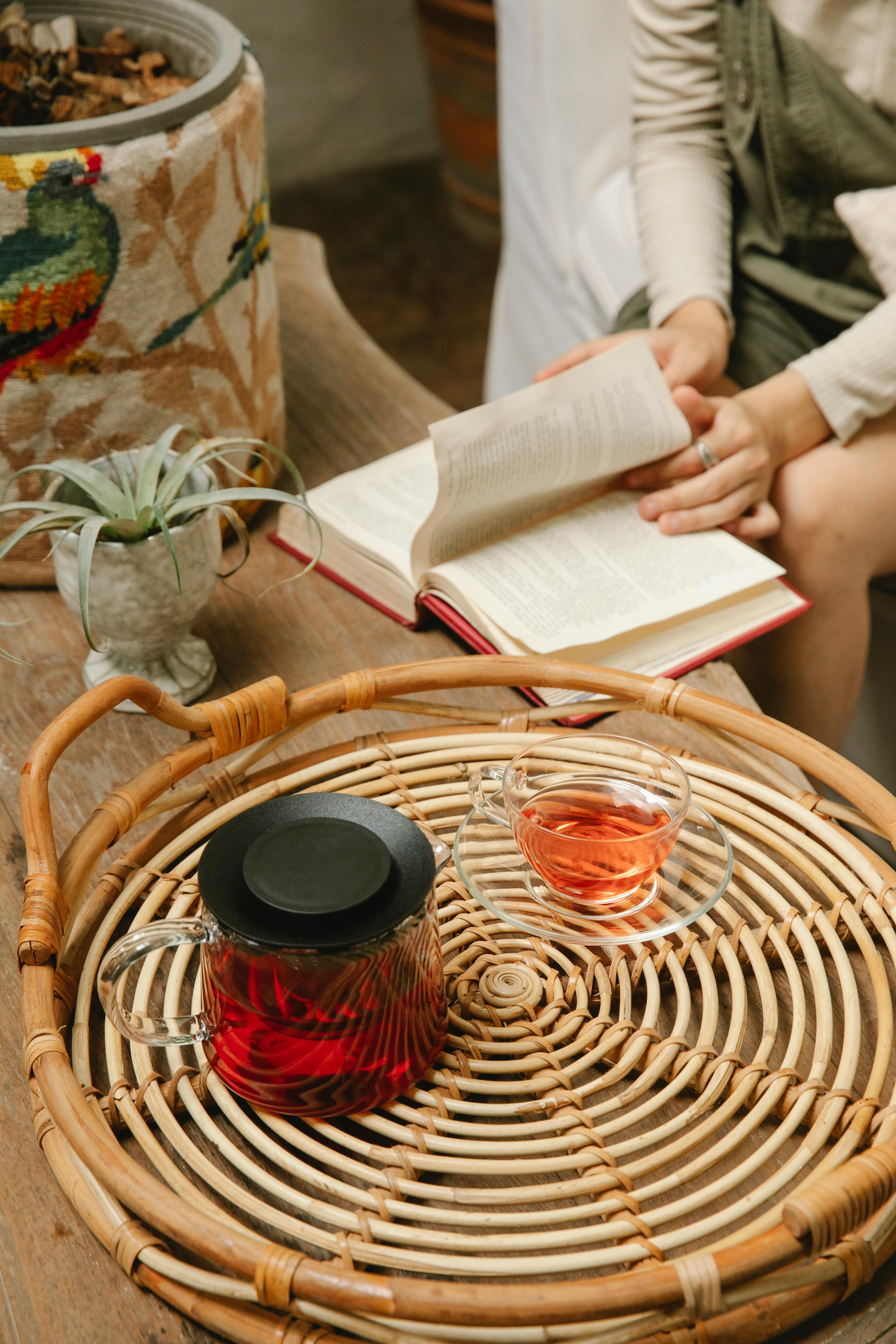 crop woman reading book in cafe