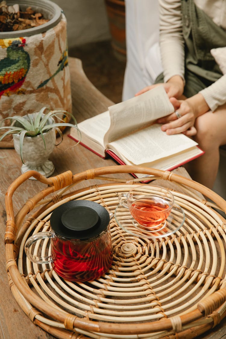 Crop Woman Reading Book In Cafe