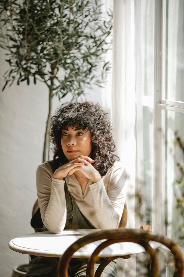 Thoughtful Customer Waiting For Order In Cafe