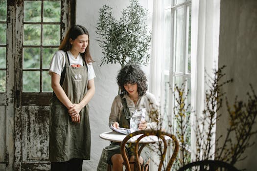 Waitress attentively taking an order from a customer in a cozy, sunlit café setting.