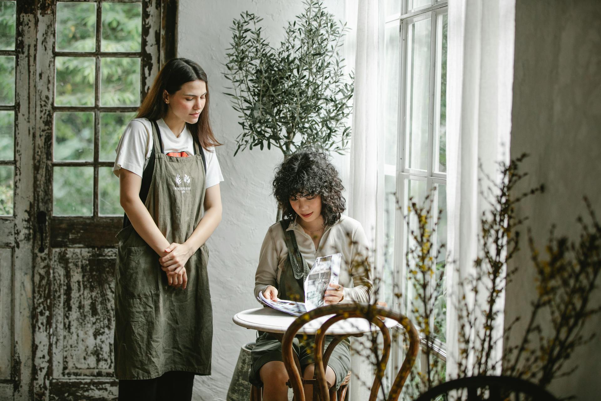 Waitress near concentrated client making order