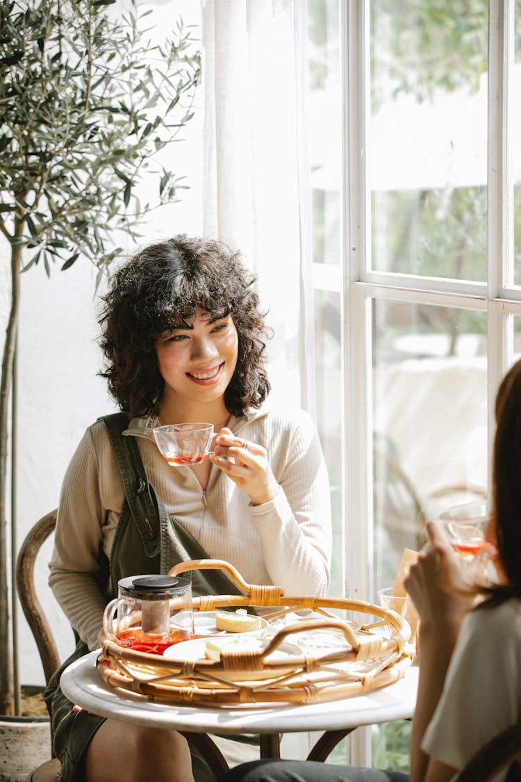 Smiling Ethnic Woman Having Breakfast With Friend