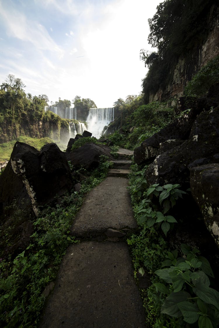 Narrow Path In Green Valley Near Amazing Waterfall