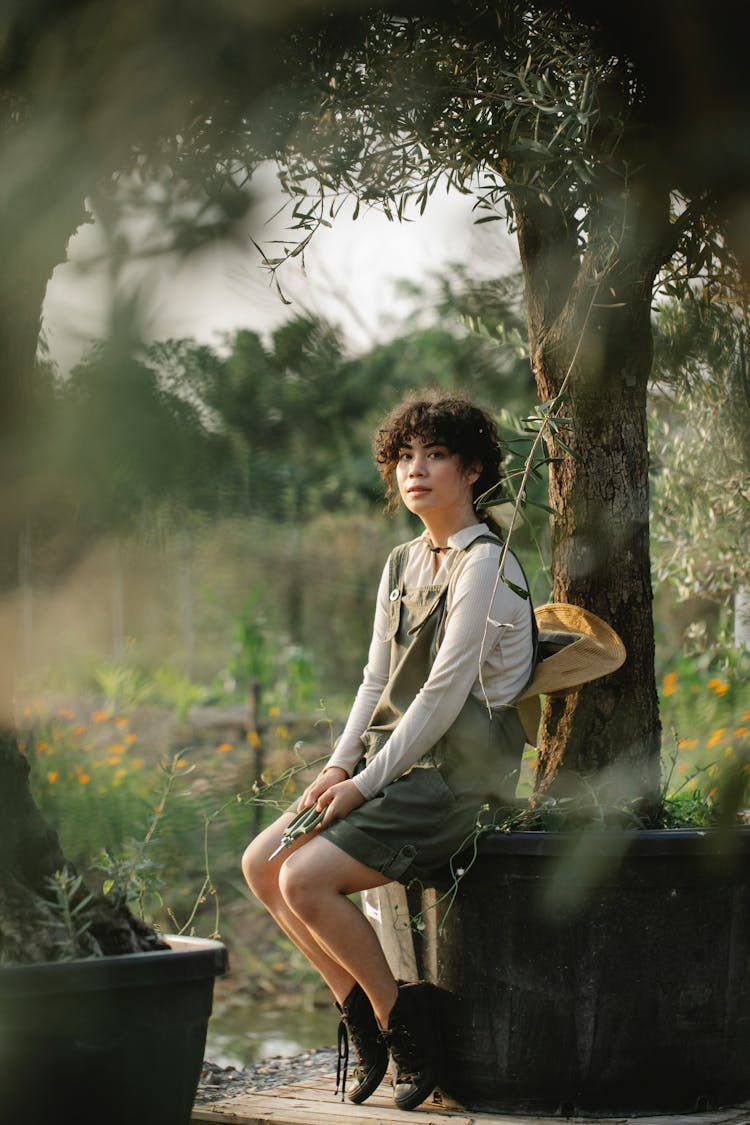 Ethnic Farmer Resting Under Olive Tree On Plantation