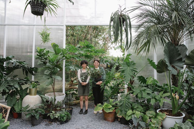 Ethnic Female Gardeners With Flowerpots