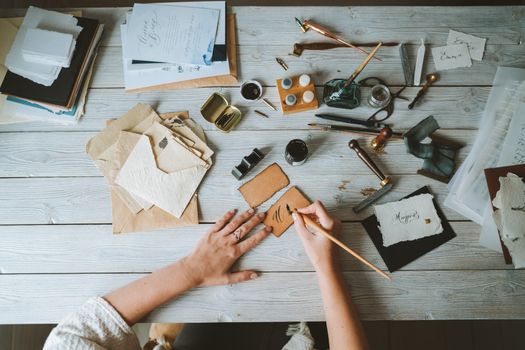A calligraphy workstation with paper and pens laid out flat.