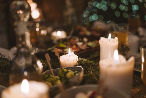 Free Warm ambiance of a candlelit dining table with festive decorations and food, perfect for holidays. Stock Photo