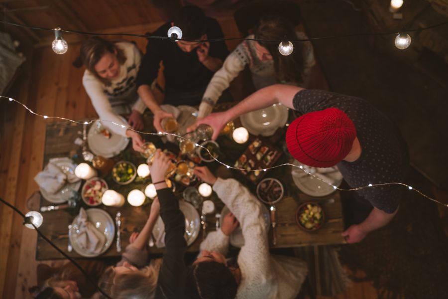Friends toasting over a supper table strung with lights, by Anastasia Shuraeva on Pexels