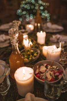 Warm and festive holiday dinner table with glowing candles and appetizers, creating a cozy atmosphere.