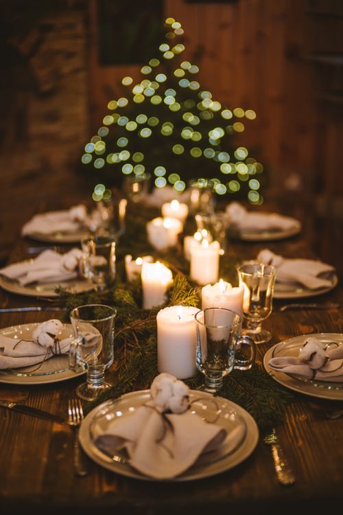 Free A beautifully arranged Christmas Eve dining table with candles and festive decorations. Stock Photo