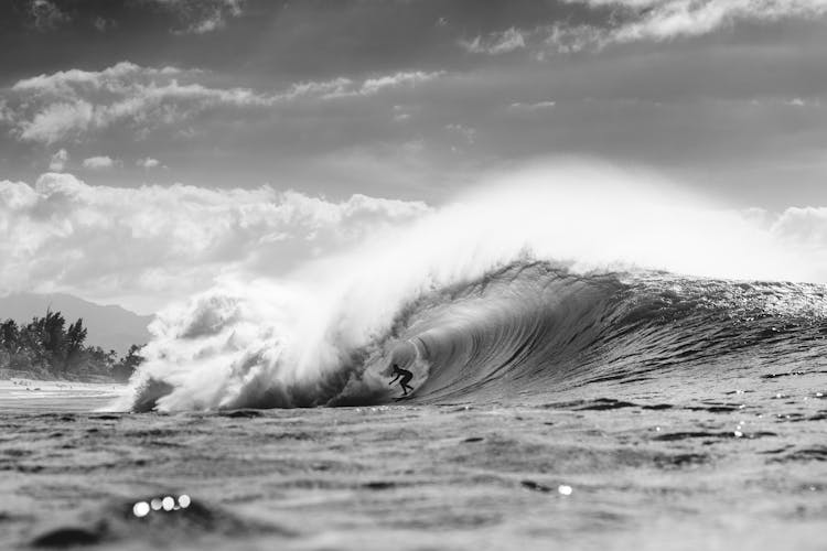 Unrecognizable Surfer In Wavy Sea