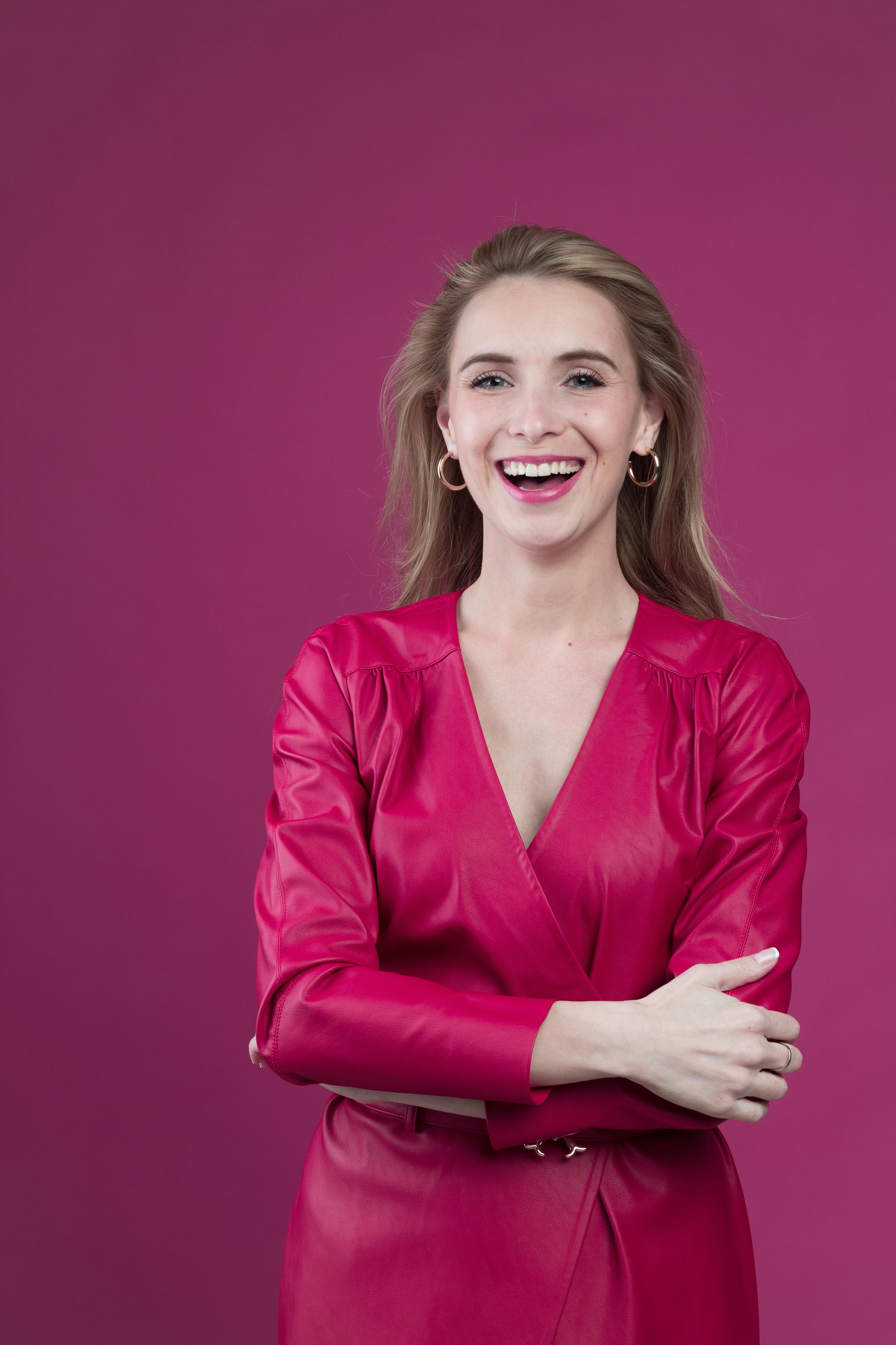 woman in red blazer smiling