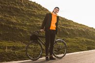 Man in Black Blazer and Orange Shirt Standing on Road Bike