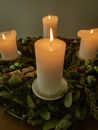 Burning candles on creative green holder