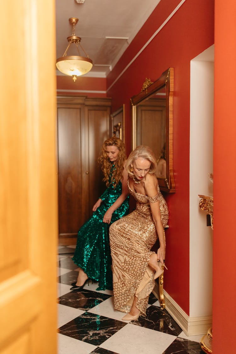 Women Wearing Elegant Evening Gowns Removing Their Heels