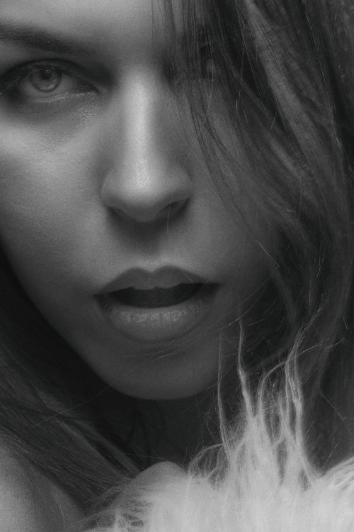Free Black and white close-up portrait of a woman's face with an expressive look. Stock Photo