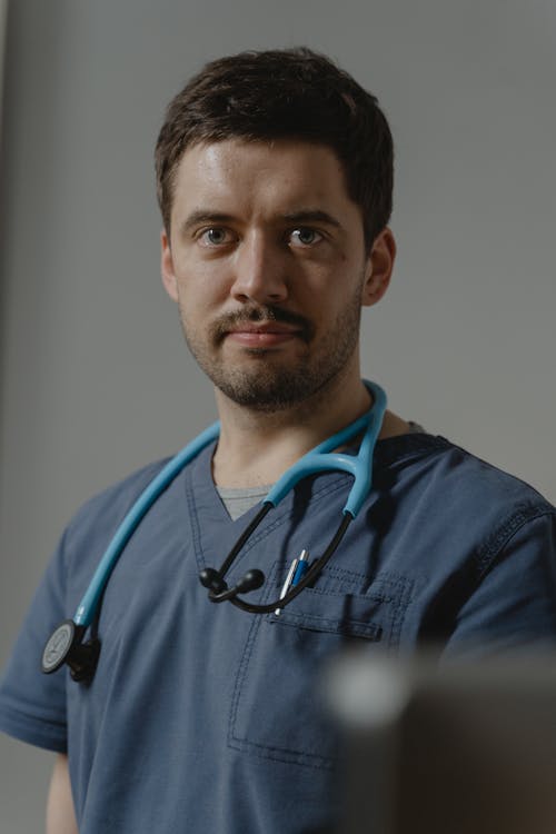 Free A Man Wearing a Stethoscope on His Neck Stock Photo