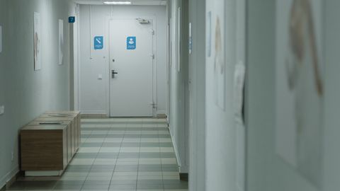 A quiet hospital hallway with soft lighting and minimal decor.