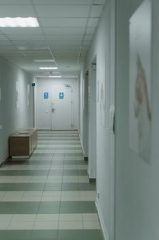 A quiet hospital hallway with soft lighting and minimal decor.