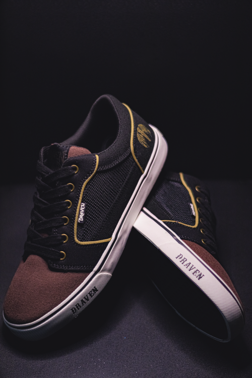 Free Close-up of Draven sneakers with black and brown design on a dark background, showcasing their classic style and design. Stock Photo