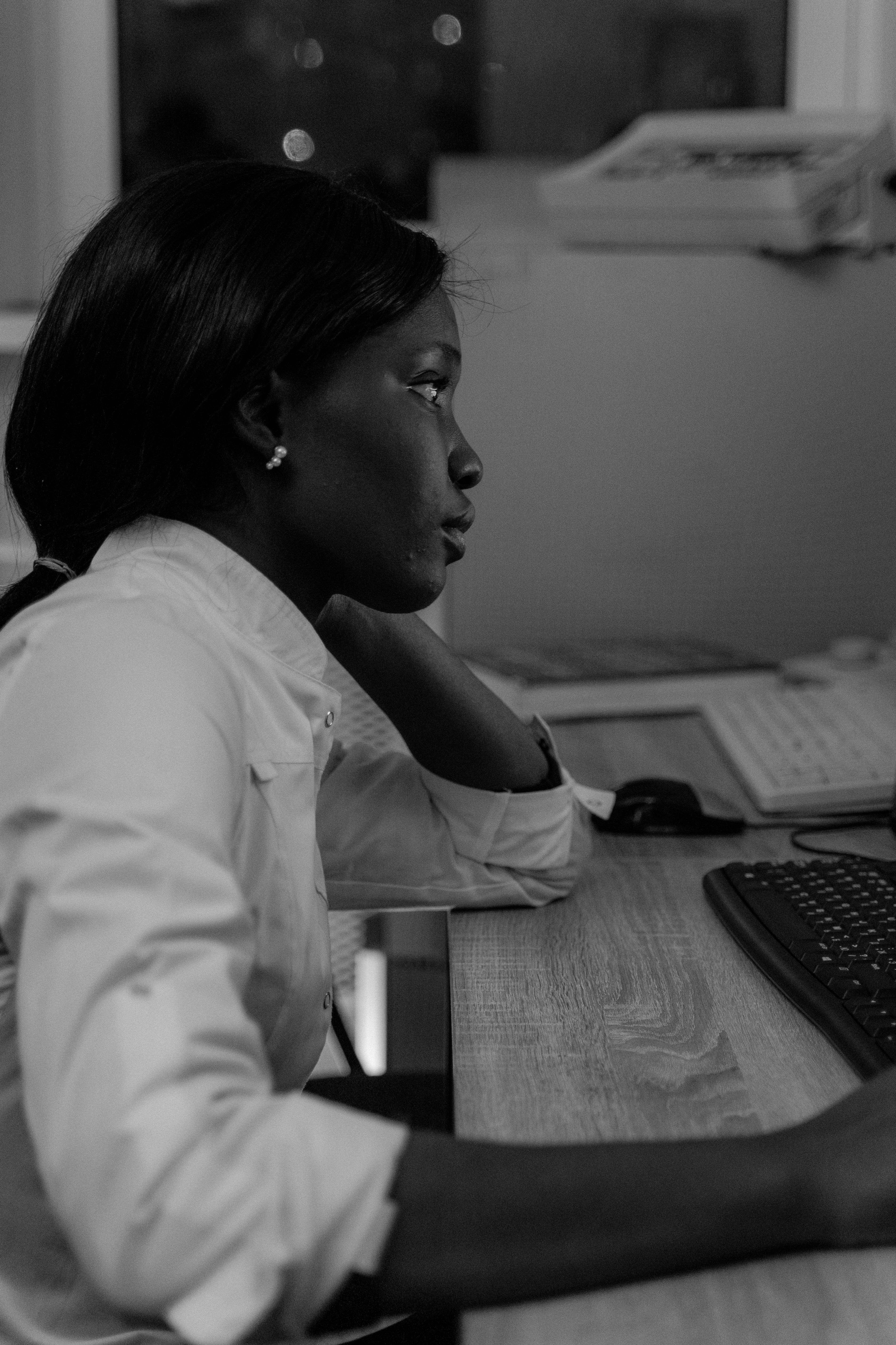 Black and White Photo of a Woman Using Computer · Free Stock Photo