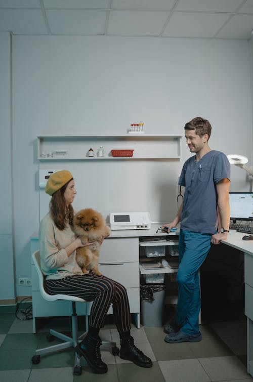 Free A Woman with Her Dog in  a Veterinary Clinic Stock Photo