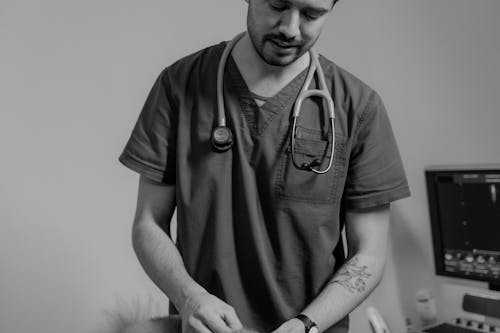 A Man in Scrub Suit with a Stethoscope Wrapped on His Neck