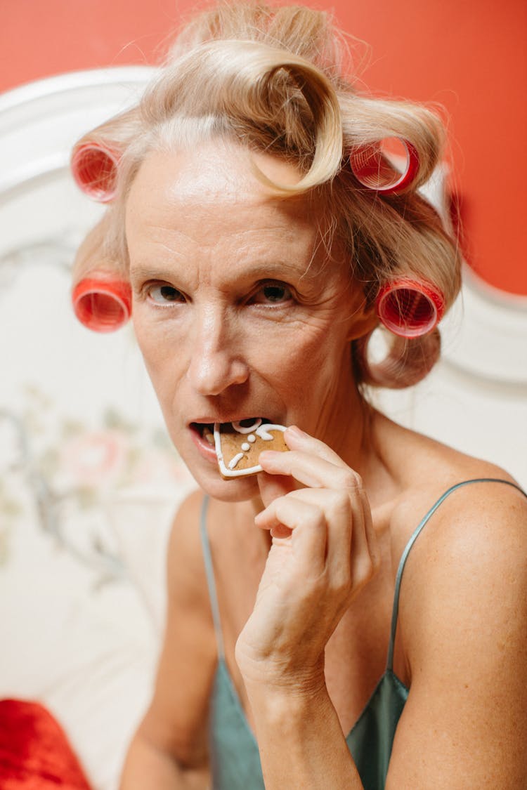 
A Woman Eating A Gingerbread Cookie