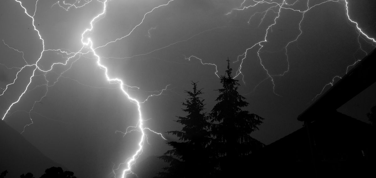 Panoramic view of thunderstorm at night