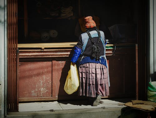 Back View of a Woman Standing by a Counter 