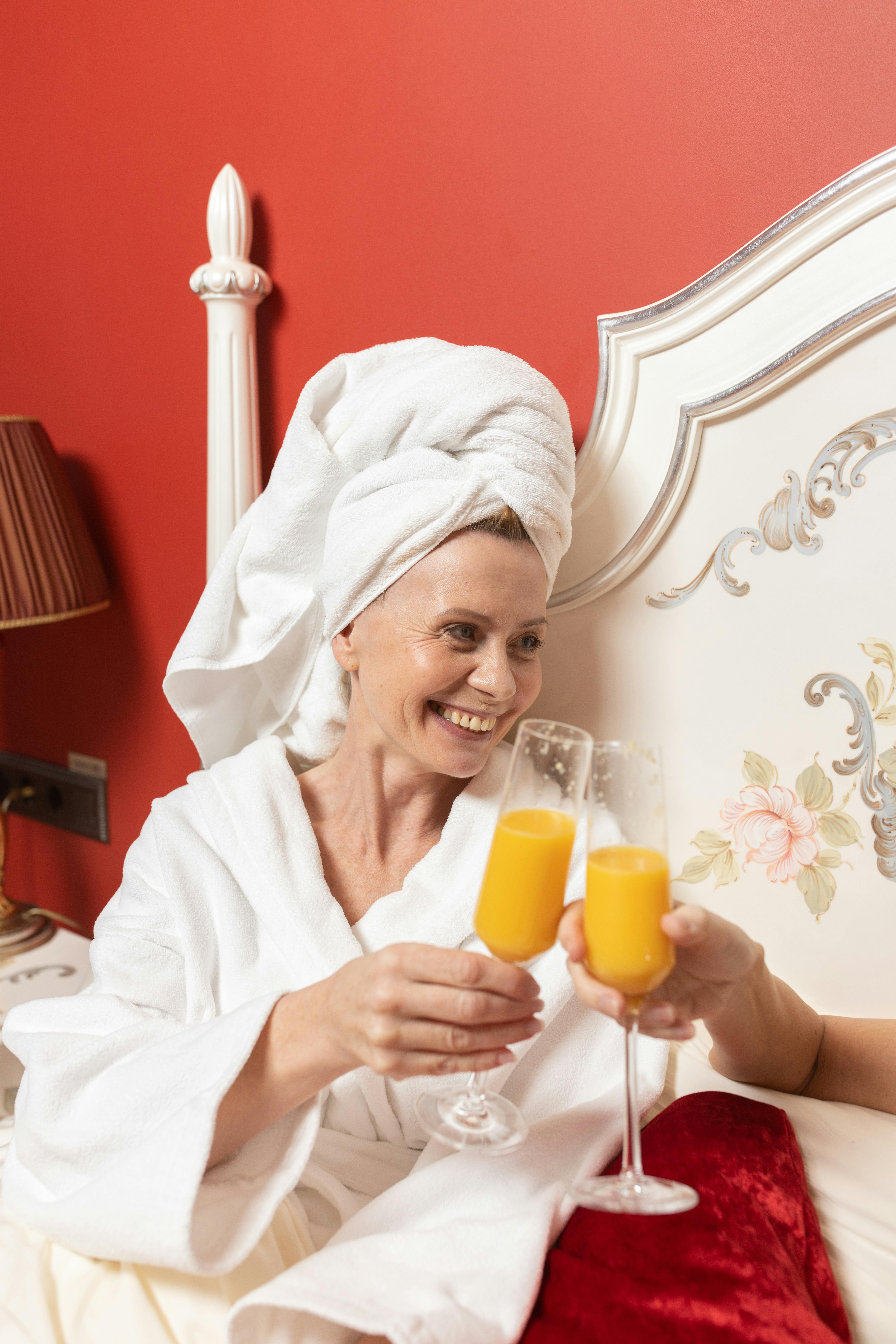 Woman in White Bathrobe Having a Toast · Free Stock Photo