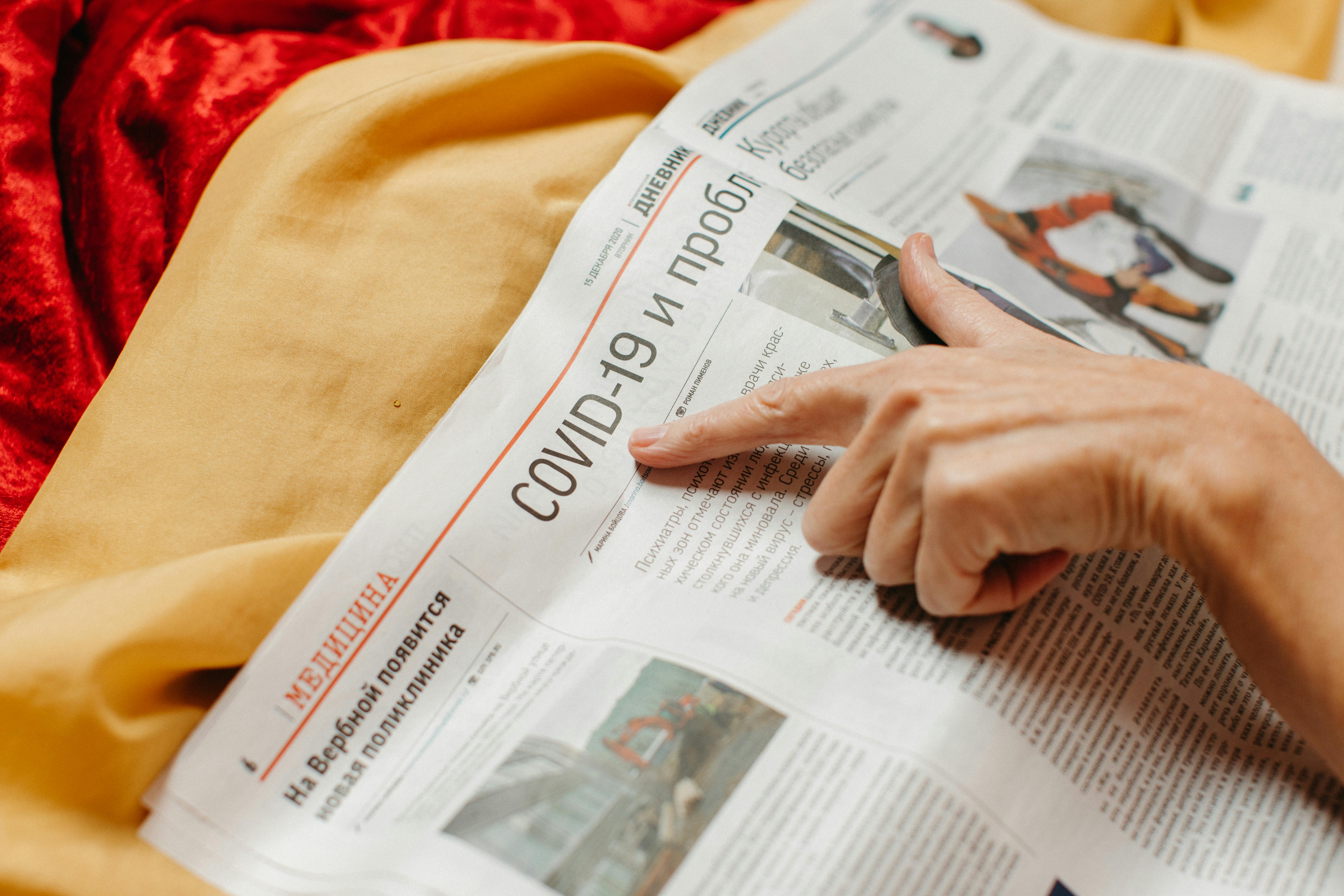 Woman Pointing on a Newspaper Page