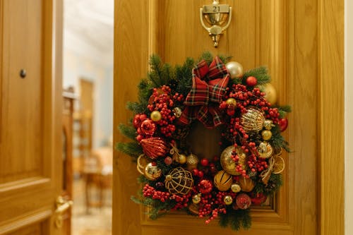 Red and Green Wreath on Brown Wooden Door