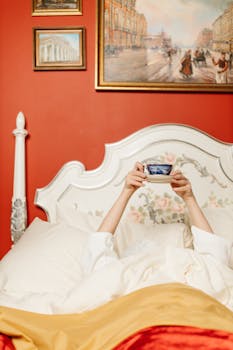Relaxed morning with a ceramic cup against an elegant bedroom backdrop.