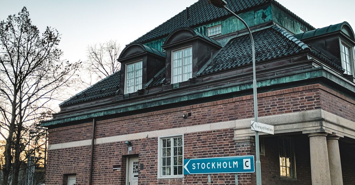 Charming brick building with a Stockholm road sign in Östermalm, Sweden.