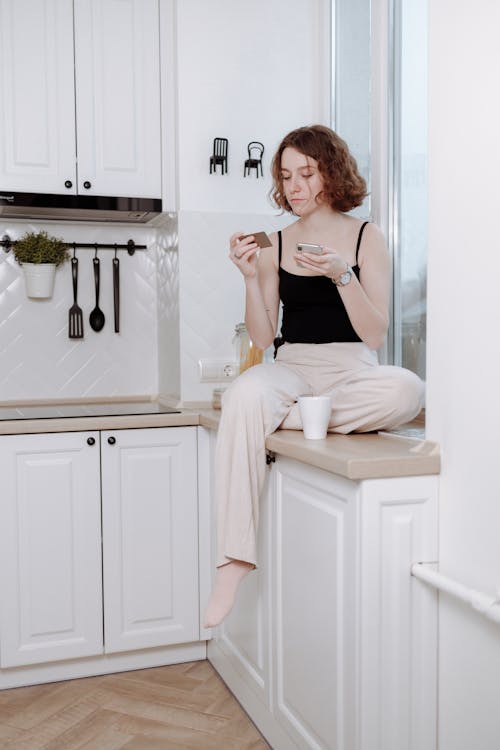 Free Person Sitting on a Counter Stock Photo