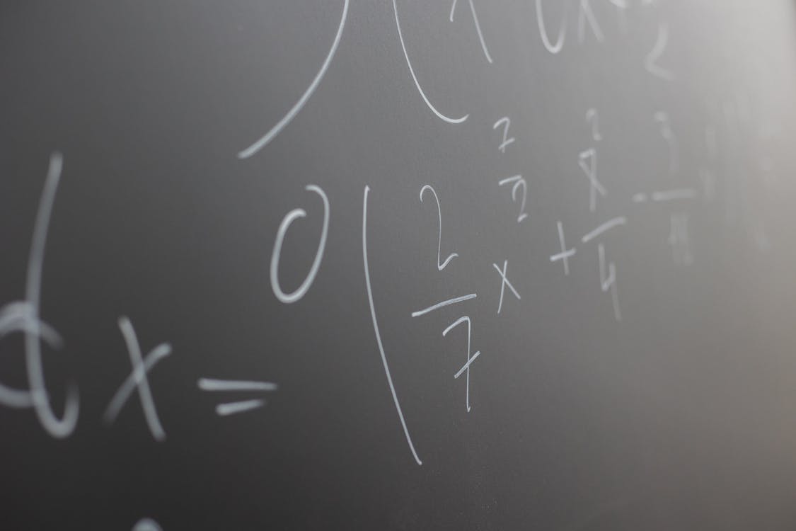 Free Blackboard with handwritten mathematical example for solve on lesson during studies in classroom of university Stock Photo