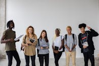 Positive multiethnic team of students standing with books