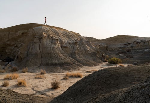 Person Standing on Rock Formation