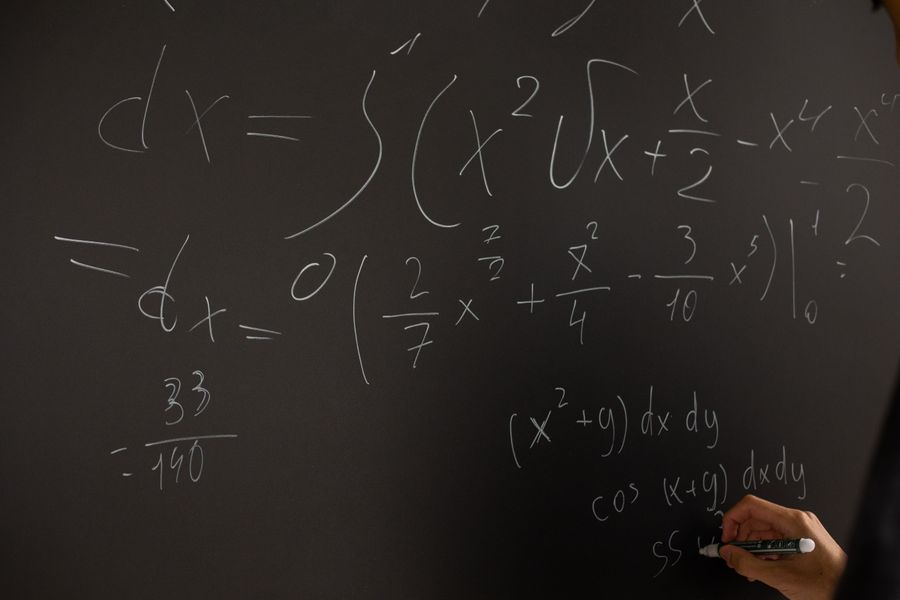 Complex equations written on a chalkboard