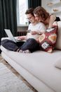 Man and Woman Smiling while Shopping Online