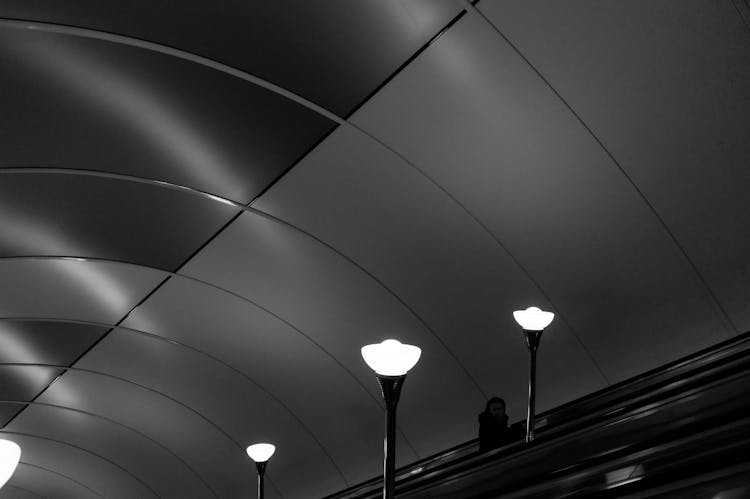 Bright Lamps Near Escalator In Dark Subway