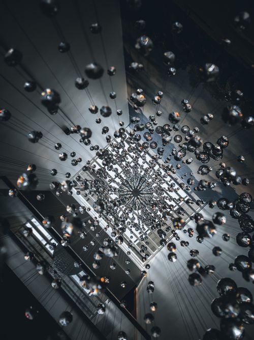 Free A captivating low-angle view of a chandelier with shimmering droplets. Stock Photo