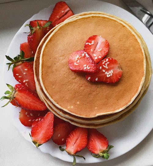 Pancakes and Strawberries on White Ceramic Plate