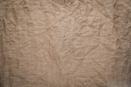 Free A Crumpled Brown Linen Textile Stock Photo