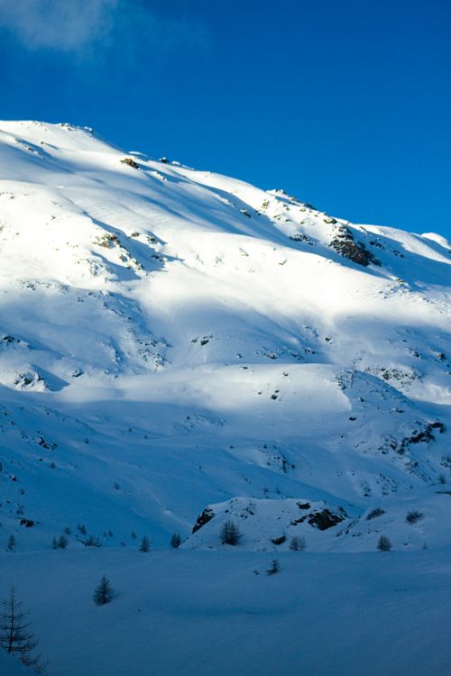 Free Breathtaking snowy mountain landscape in Lombardy, Italy with clear blue skies. Stock Photo