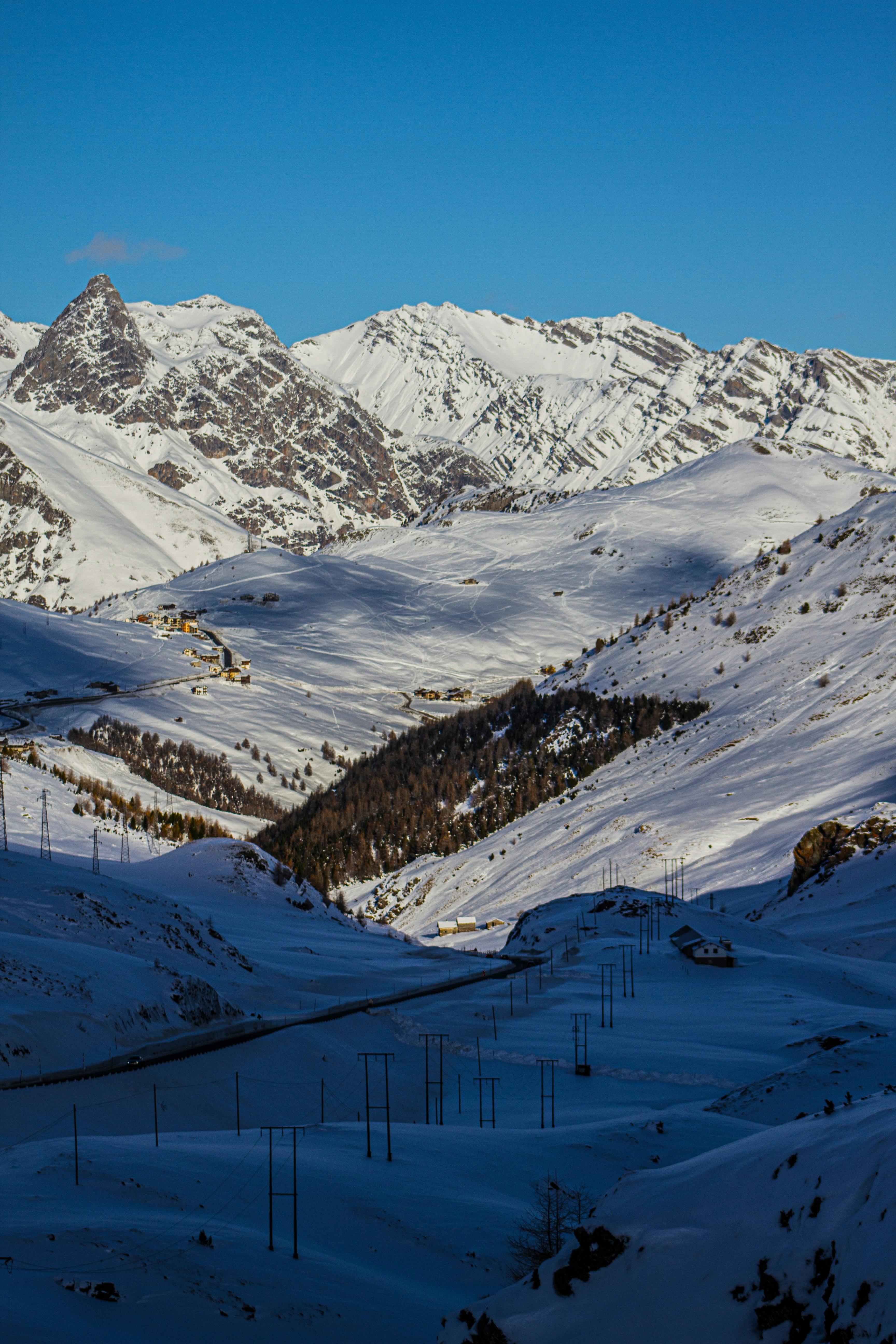 Prescription Goggle Inserts - Striking aerial view of snowy mountains in Livigno, Italy under a clear blue sky.